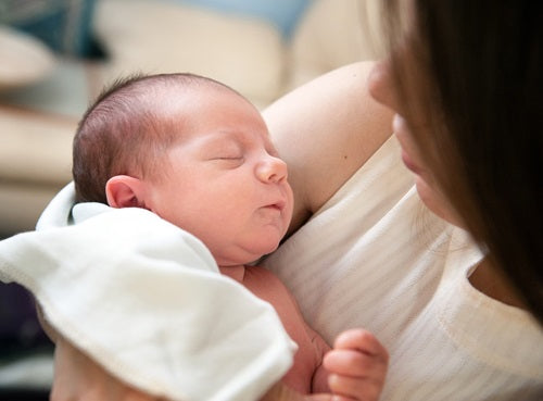 mom holding new baby