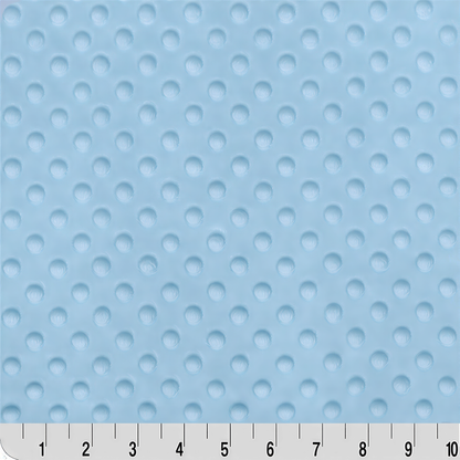 a close-up view of a light blue fabric with a dotted pattern. The fabric appears to be soft and textured, suitable for use in clothing or bedding.