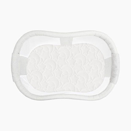 A white, oval-shaped baby crib with a mesh cover.