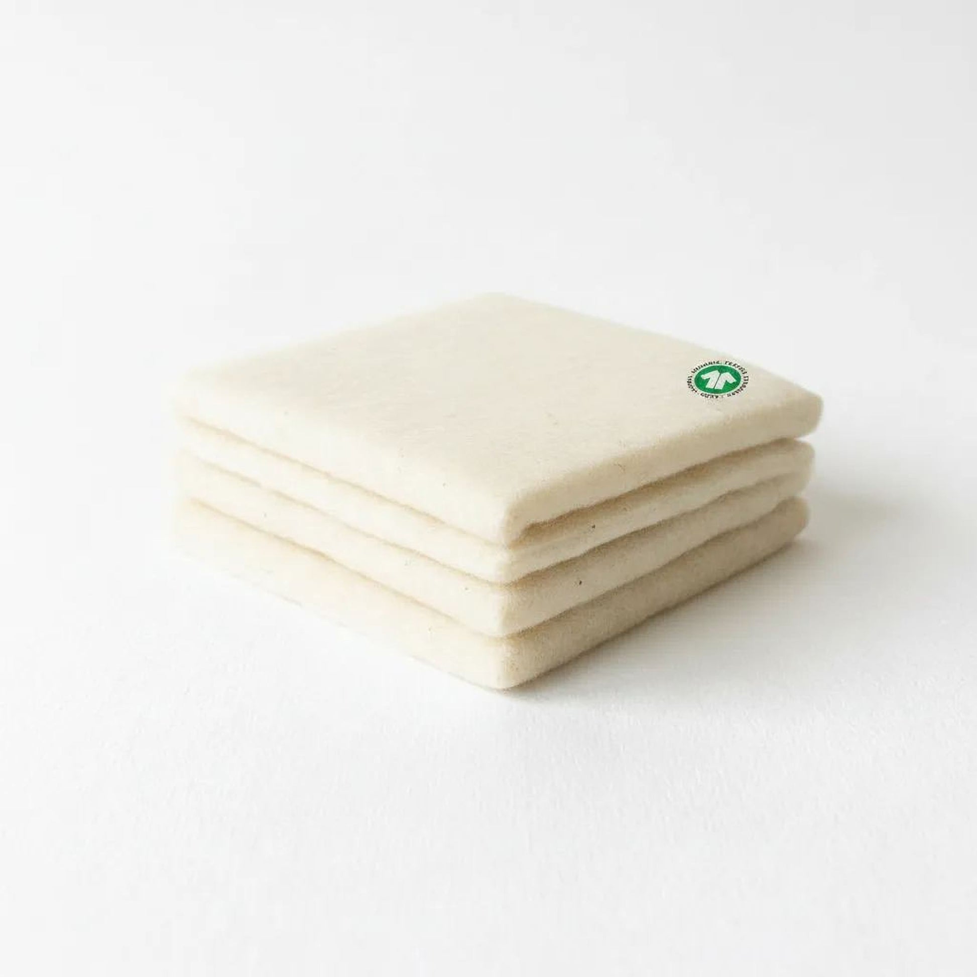 A stack of white, rectangular objects with a green circular logo on the top.