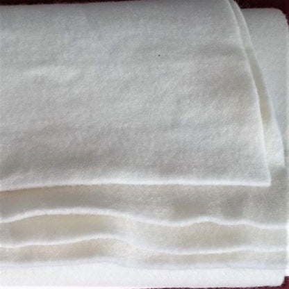 A close-up image of a pile of white, fluffy material, possibly a soft fabric or a pile of cotton balls.