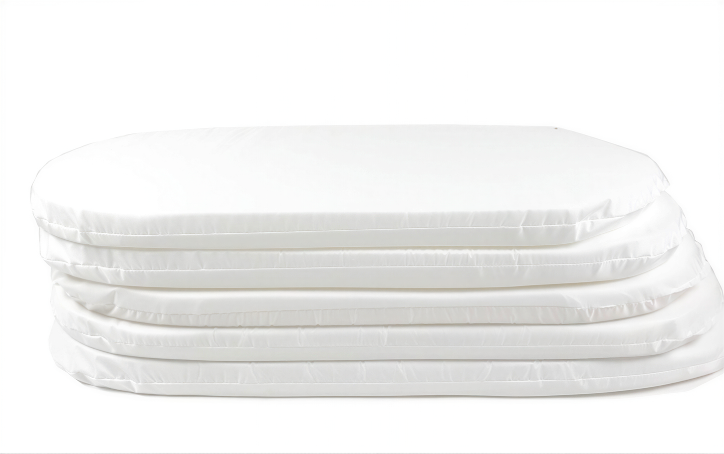 A stack of white rectangular foam mattresses.