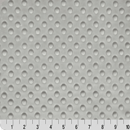 a close-up view of a surface with a repeating pattern of small white circles or dots, creating a textured or perforated appearance.