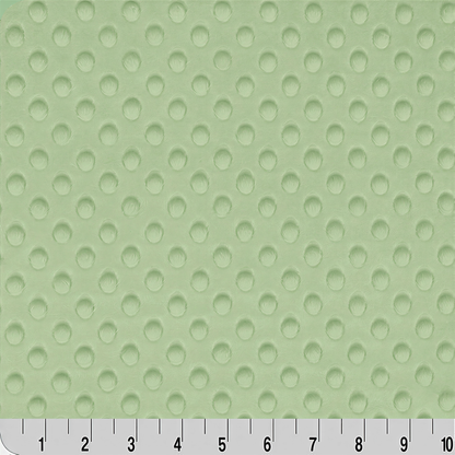 a close-up view of a fabric with a green polka dot pattern. The fabric appears to be a soft, textured material with a repeating pattern of small circles. The image does not contain any text or other objects, and the focus is solely on the fabric's texture and color.