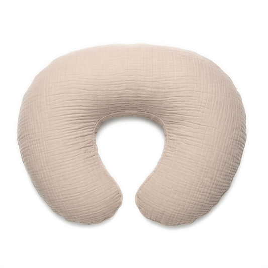 A beige, textured baby crib pillow is shown against a white background.