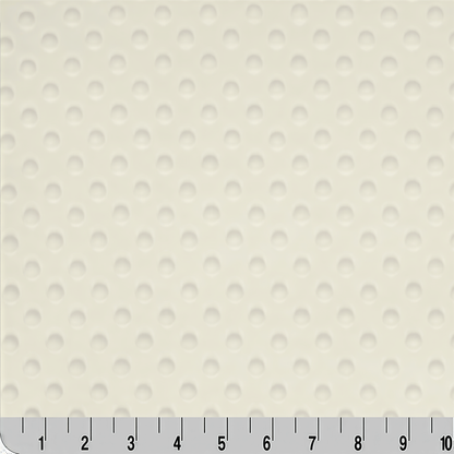 a close-up view of a fabric with a repeating pattern of small white circles or dots, creating a textured appearance.