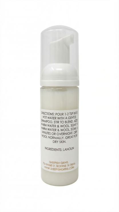 a bottle of a white liquid, likely a shampoo or conditioner, with a label that provides directions and ingredients.