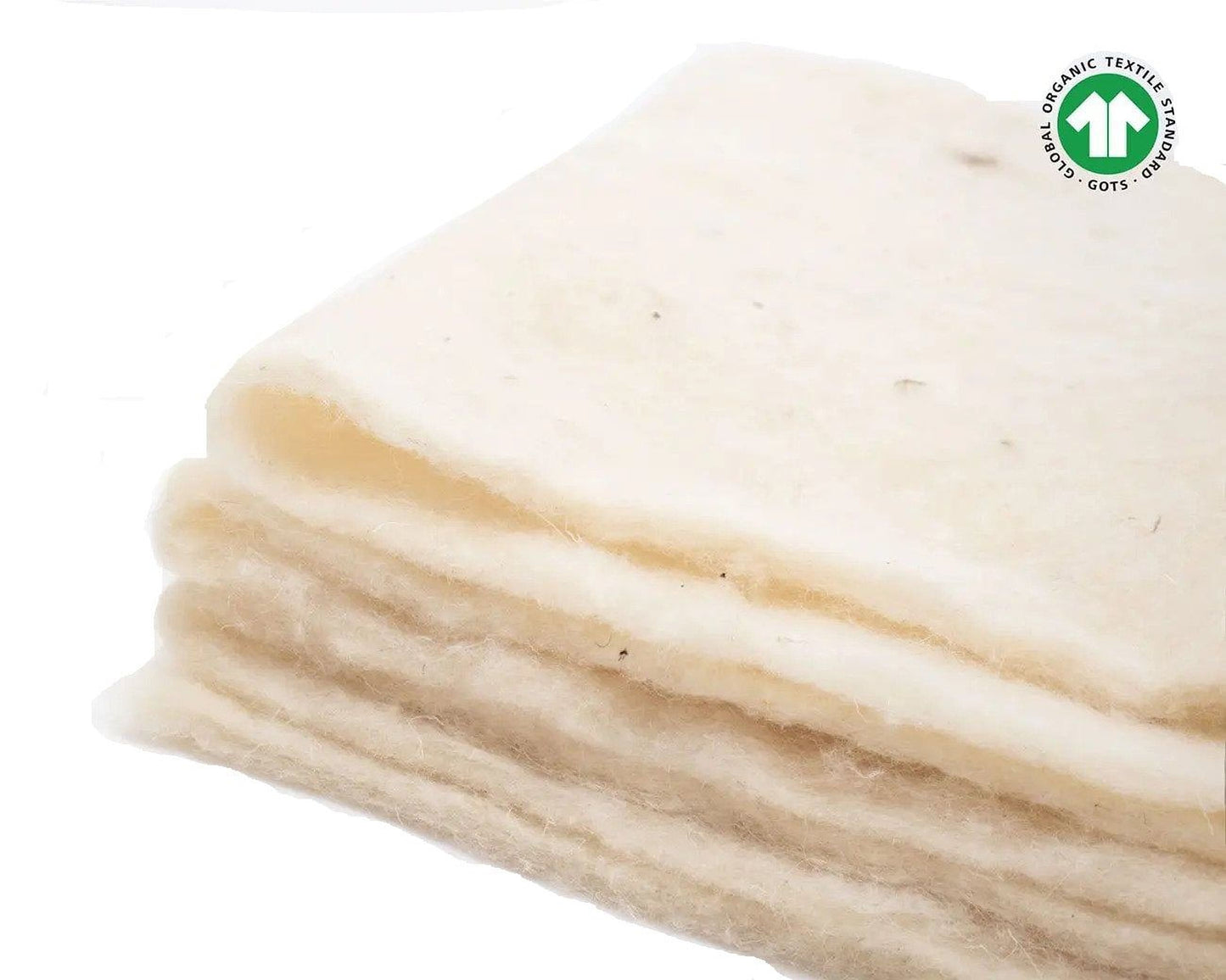 A stack of white, fluffy material, possibly cotton or a similar natural fiber, against a white background.