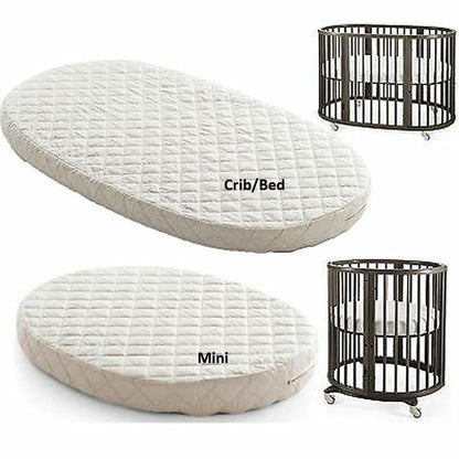 a variety of baby crib and bedding products, including a large oval-shaped mattress, a smaller circular mattress, and a metal crib.