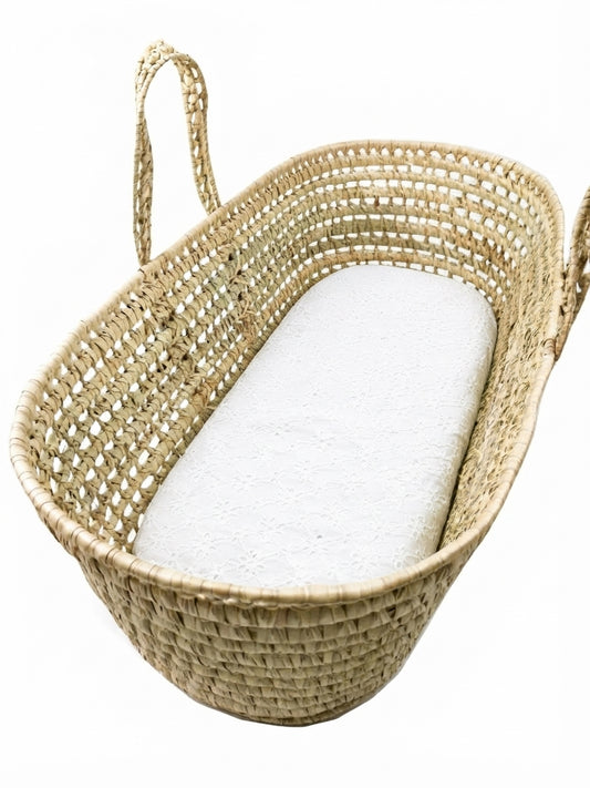 A woven basket with a white mattress inside.