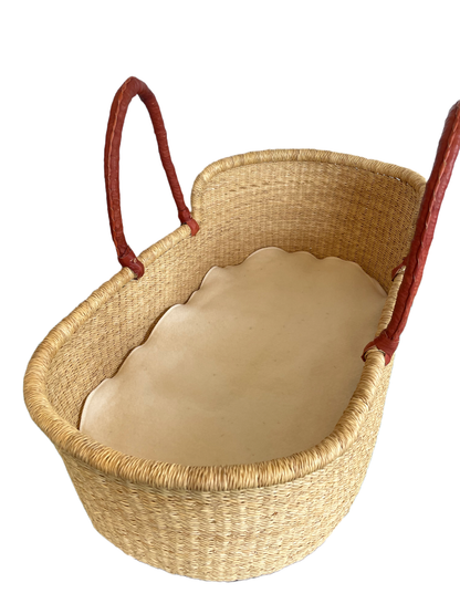 A woven basket with a white interior, featuring two red handles on either side.